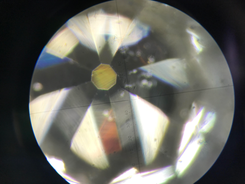 A polished diamond tip seen under a microscope.